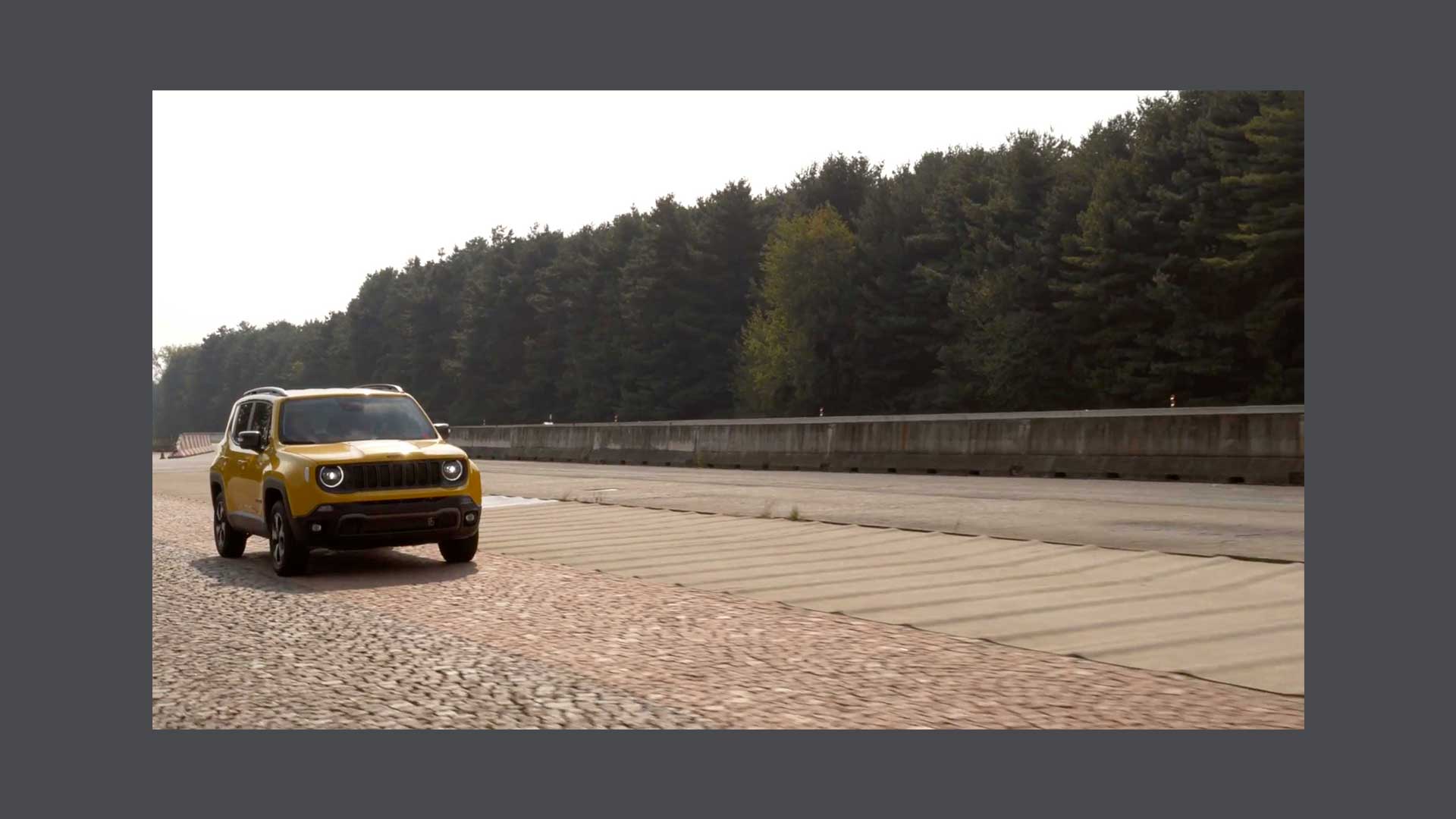 Photo of a yellow Jeep Renegade on paved road