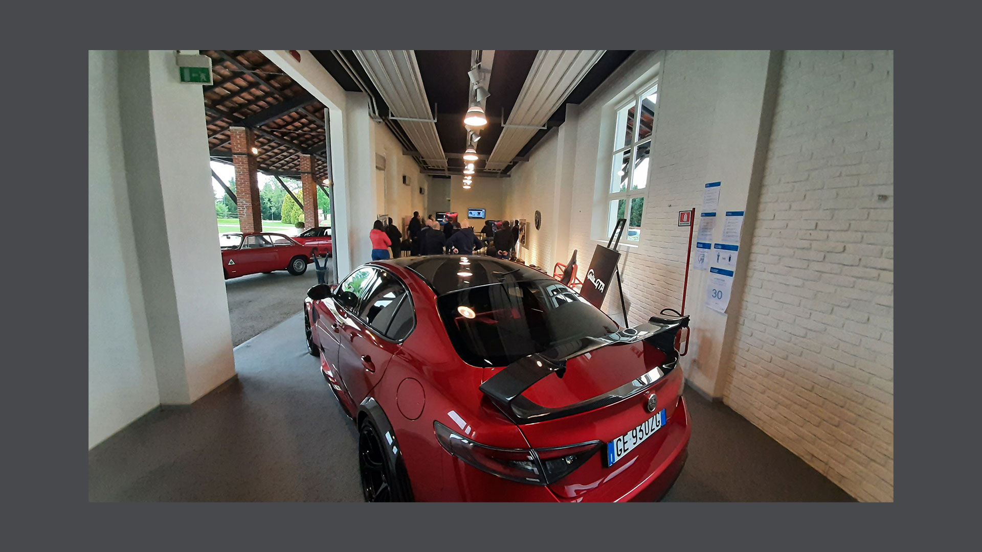 Photo of a red Alfa Romeo car inside the Autodelta