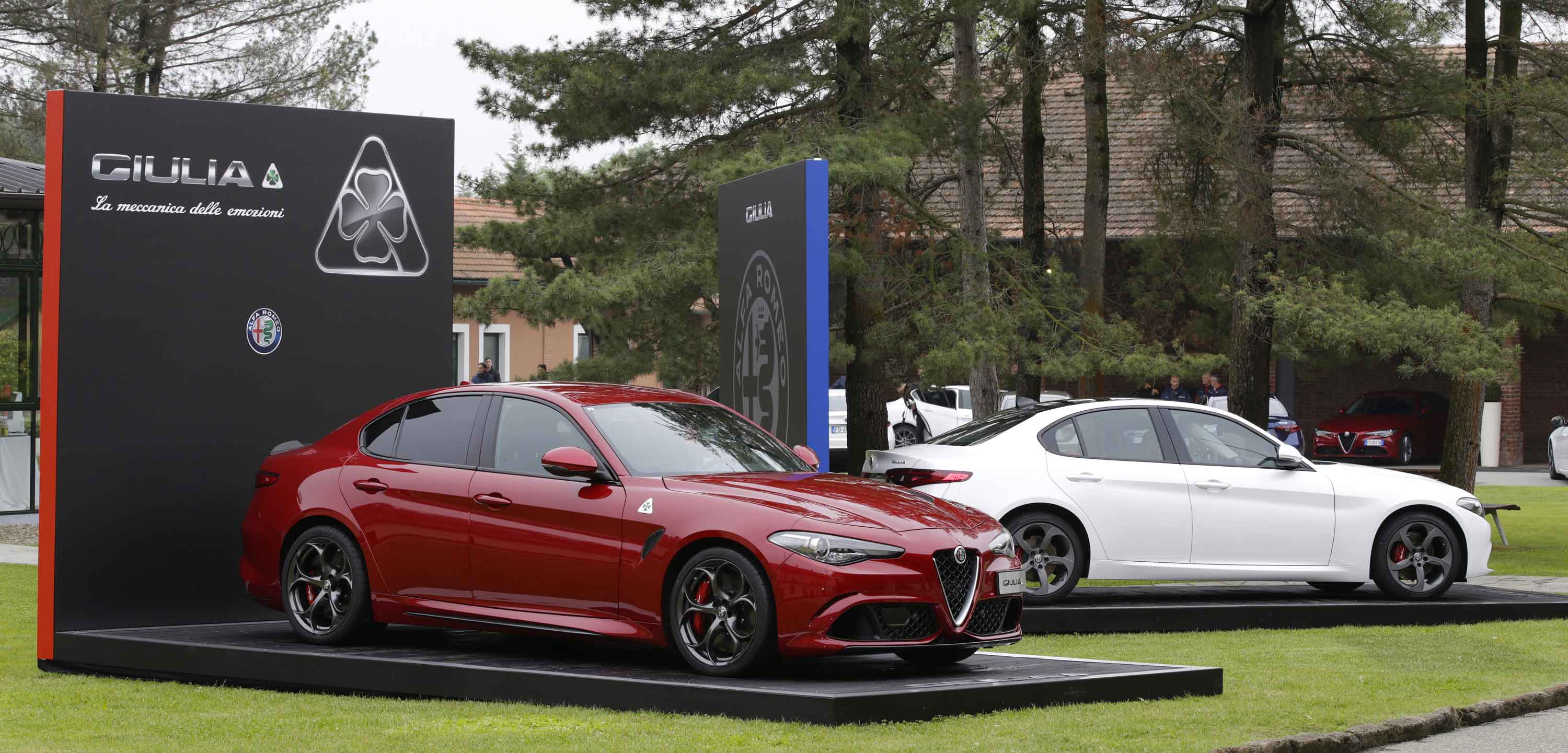 Photos of the presentation set-up of a red Giulia and a white Giulia