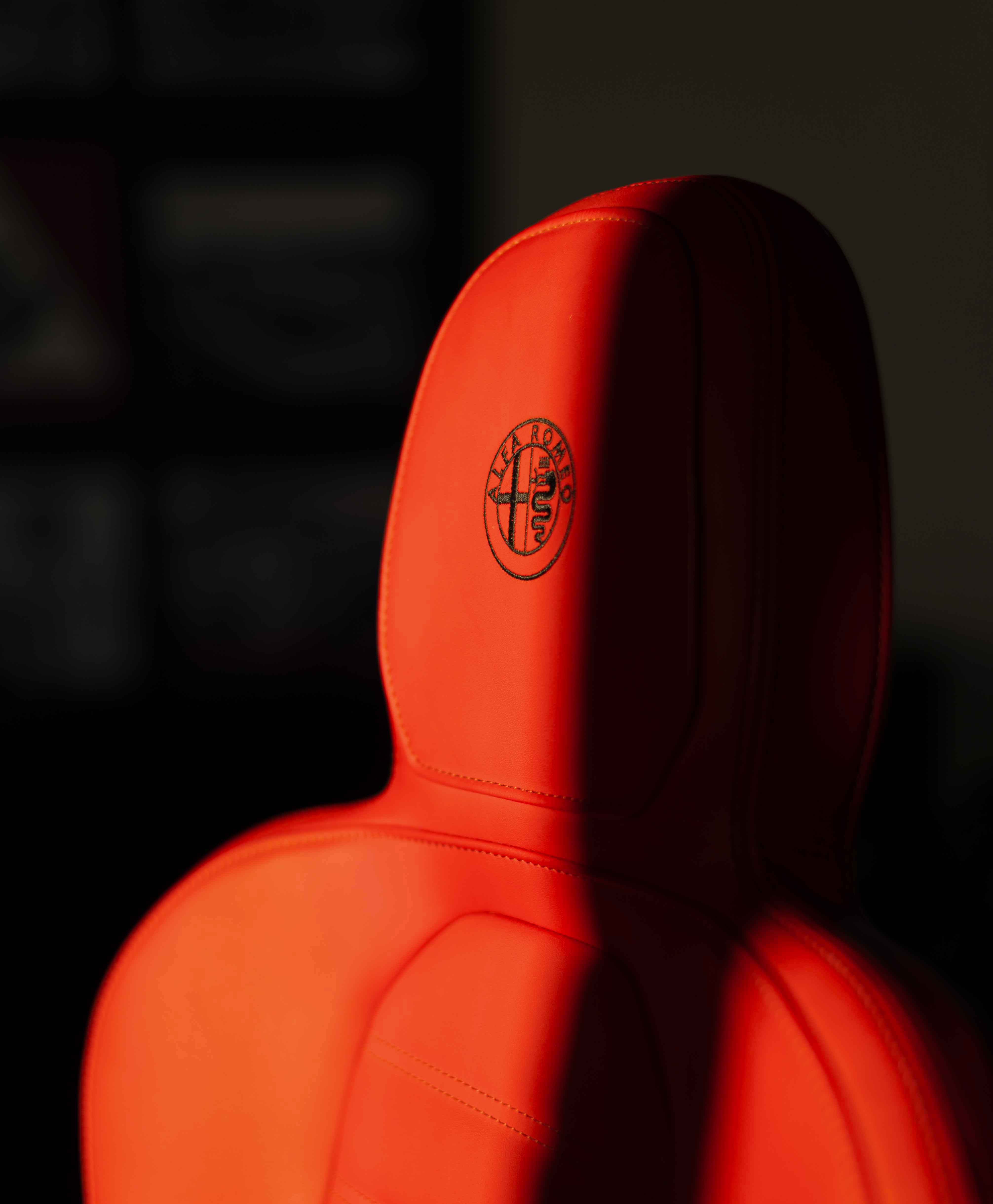 Photo of a red seat of a car branded Alfa Romeo 