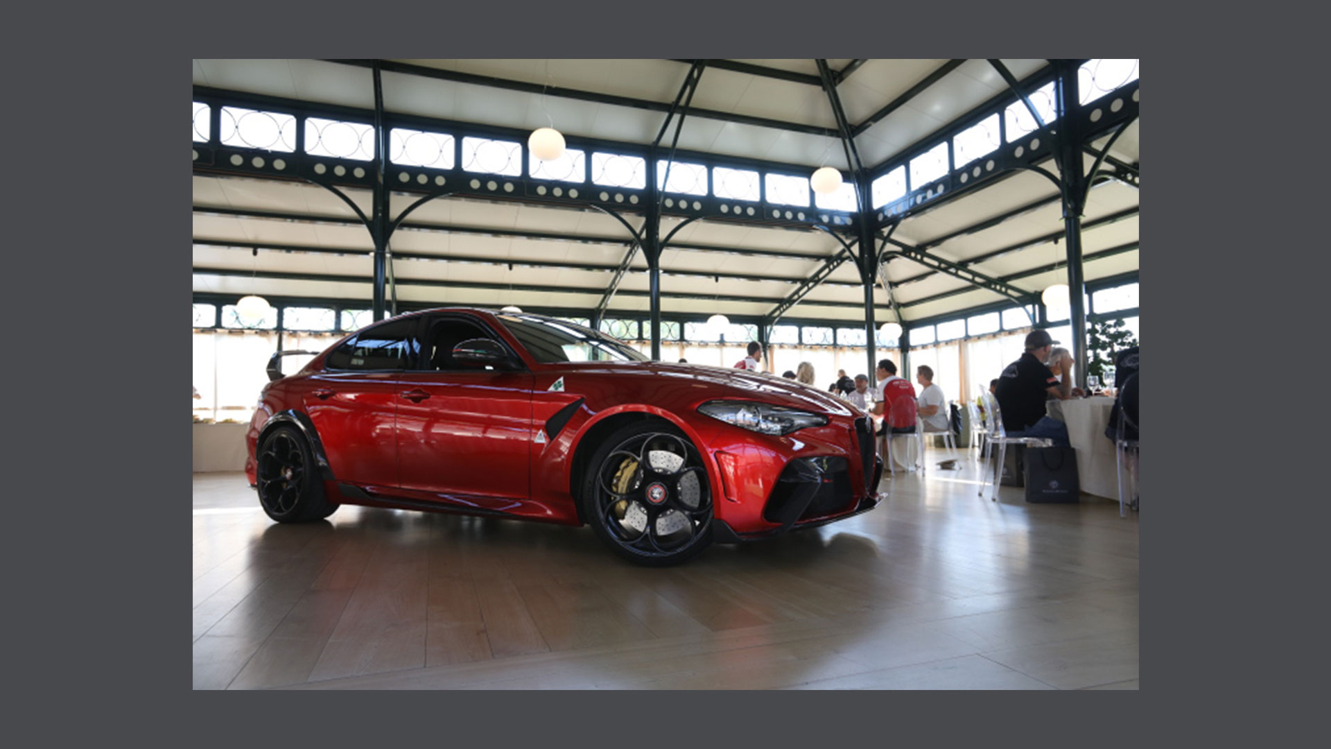 Photo of a red Giulia Alfa Romeo inside the Exterior Pavilion