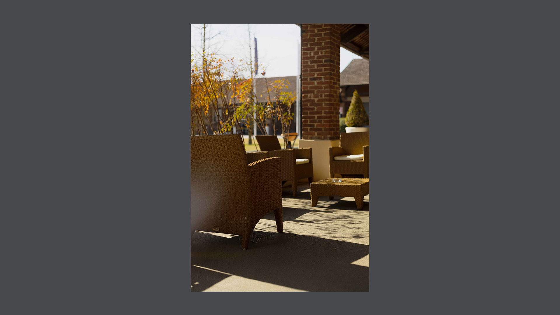 Photo of a particular of the porch furnished with wicker lounges