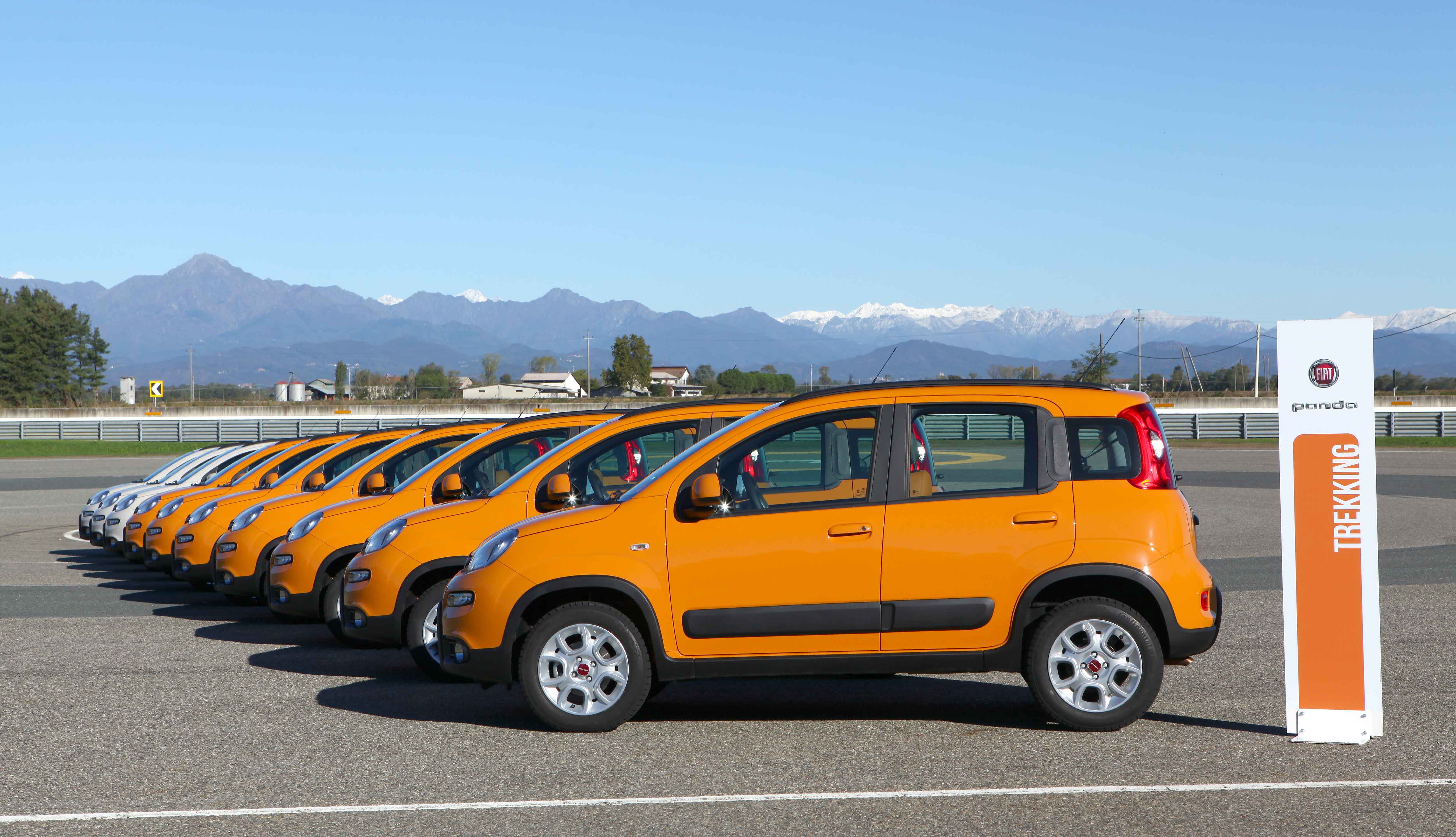 Photos of orange and white Pandas parked on a track 