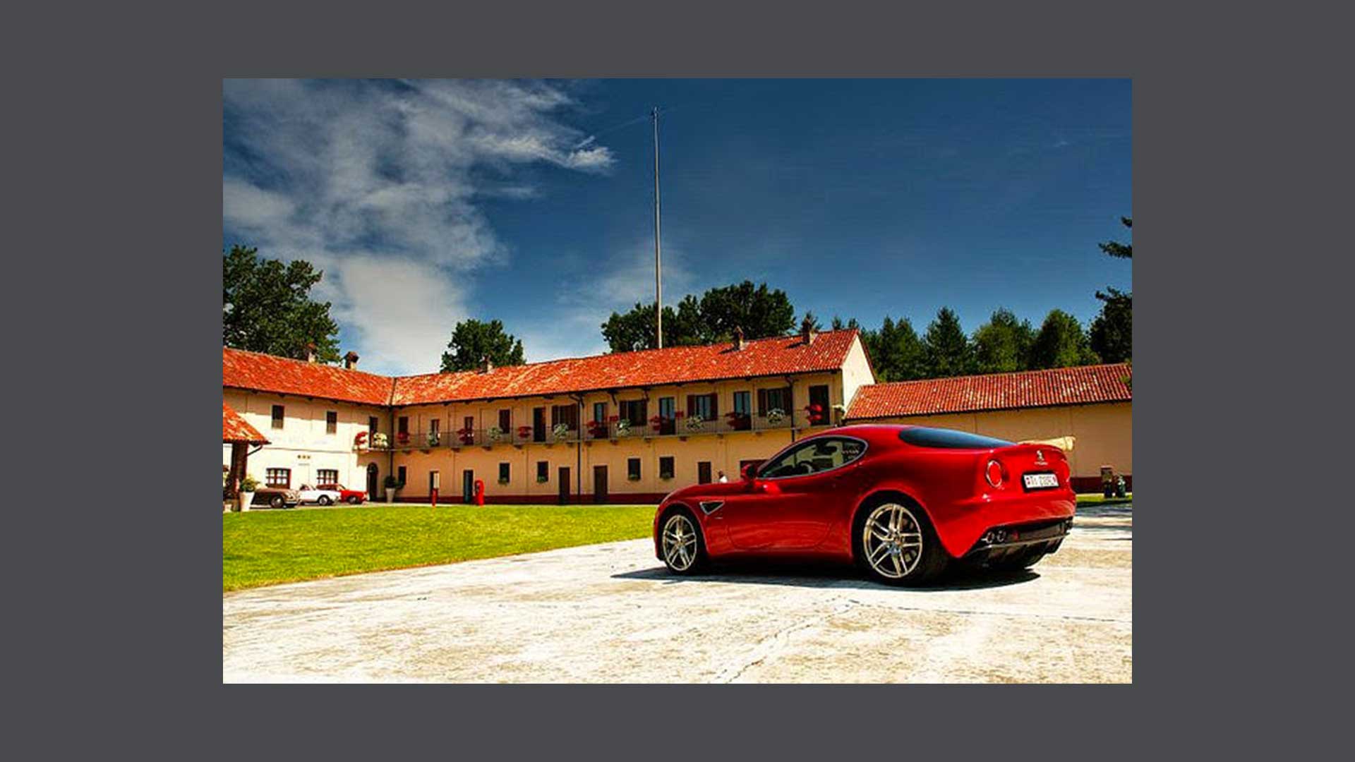 Photo of an Alfa Romeo car in front of a building in Balocco