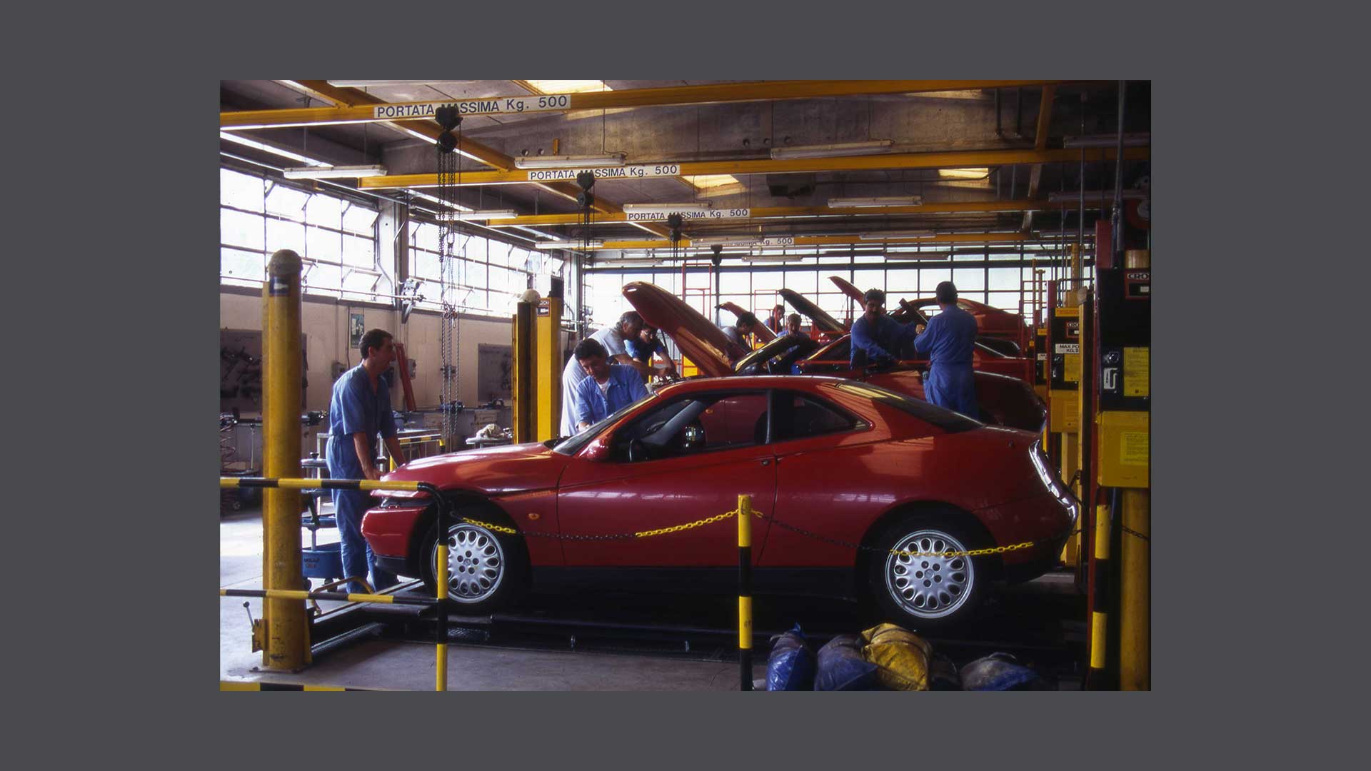 Photos of mechanics fixing a car