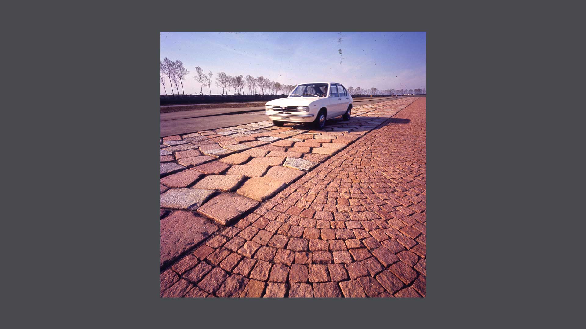 Historic photo of a white car on paved ground