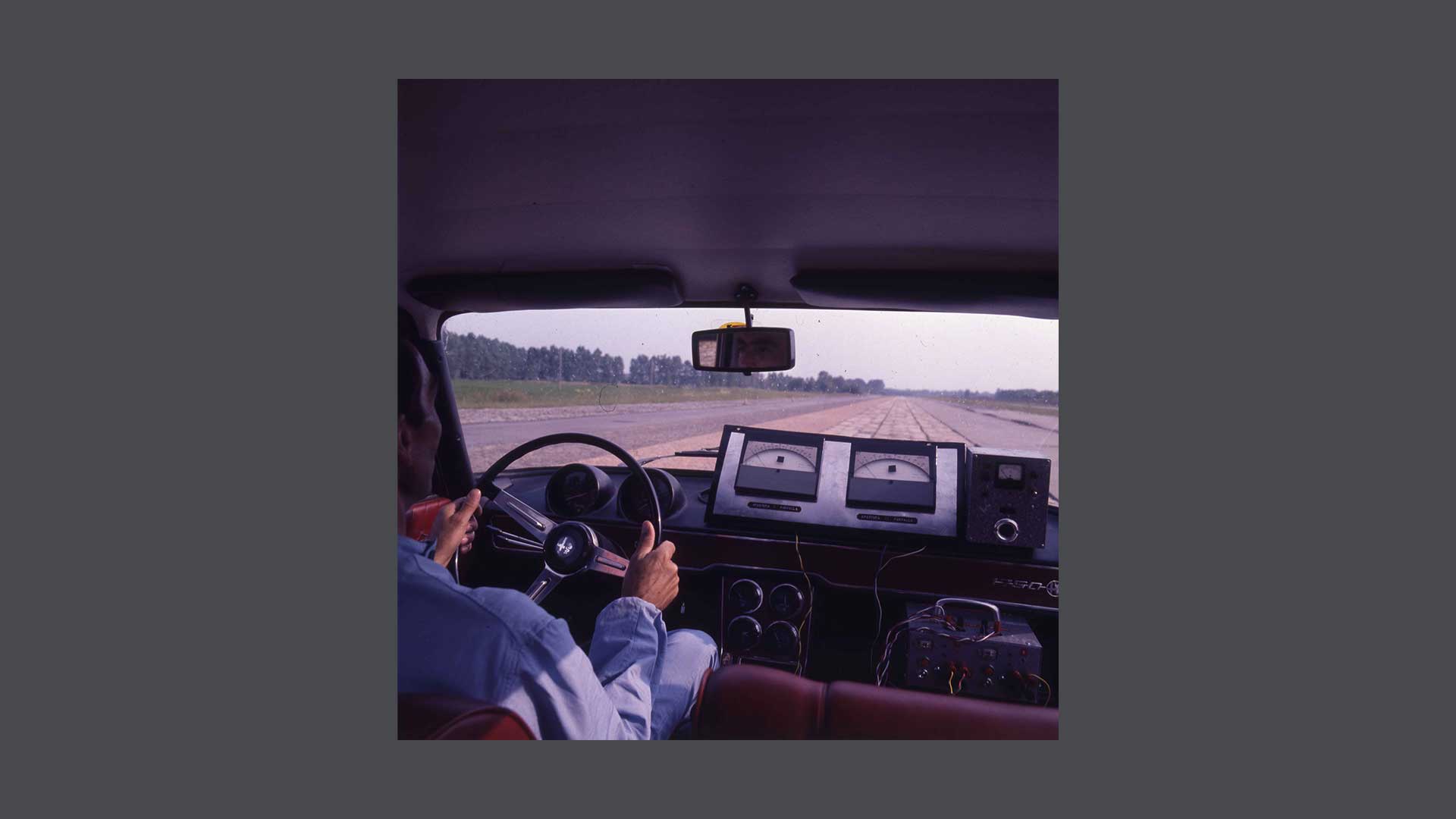 Historic photo of the passenger compartment of a car with driver