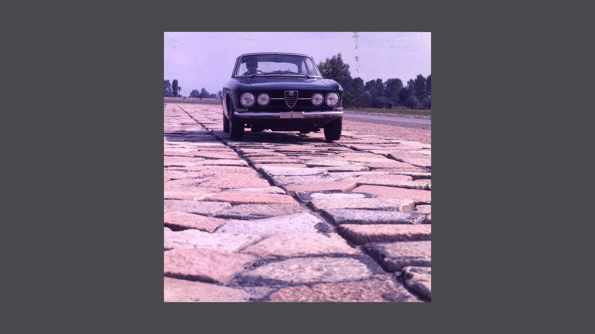 Historic photo of a car on paved ground