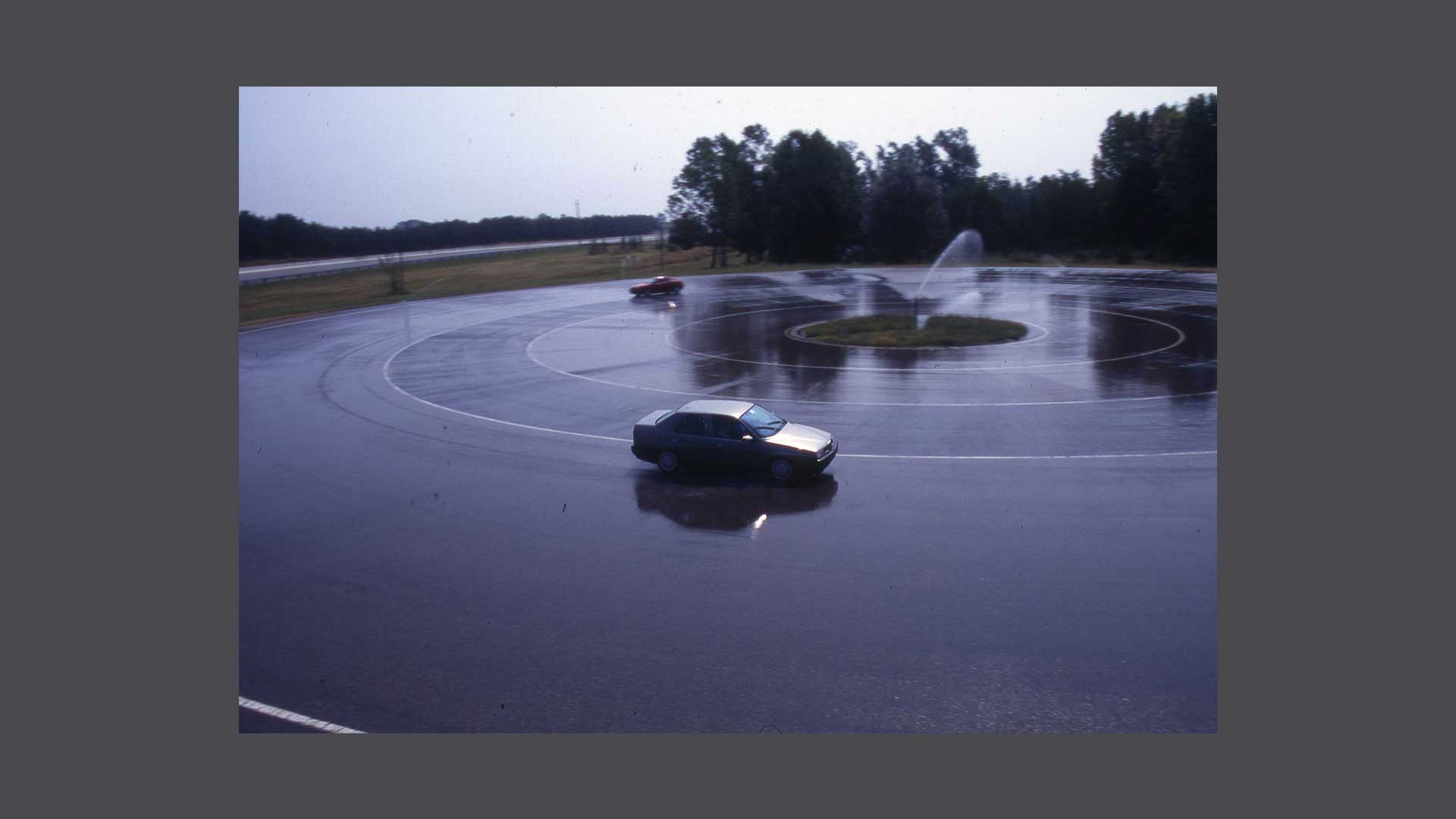 Historic photo of cars on circular track