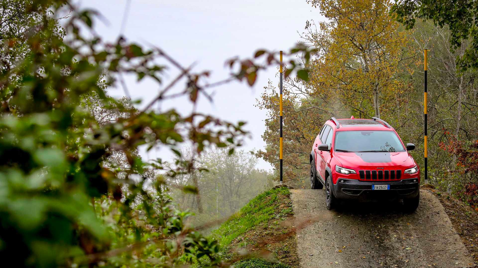 Photo of a red Jeep tackling an obstacle on the Off Road track