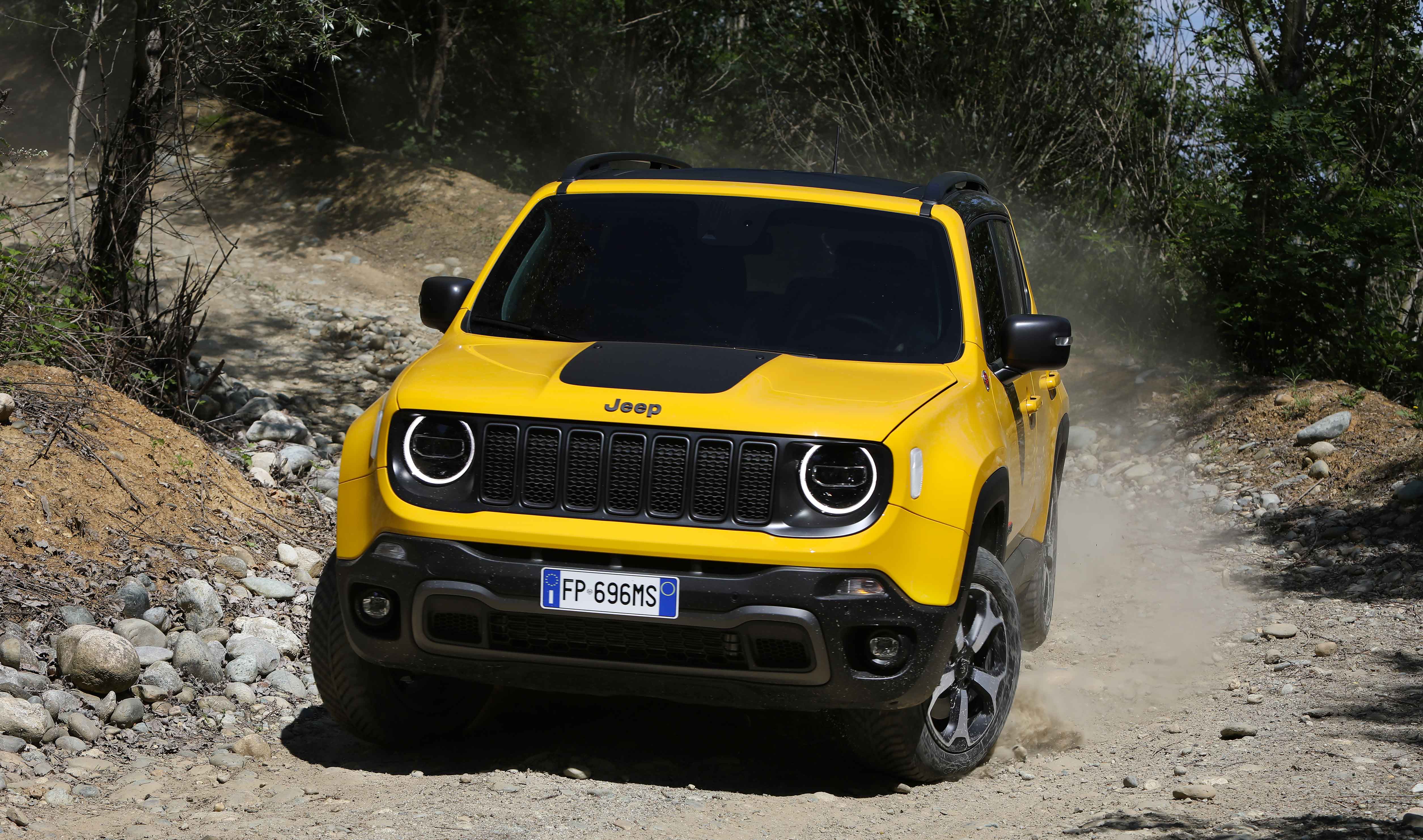 Photo of a yellow Jeep tackling a dirt road
