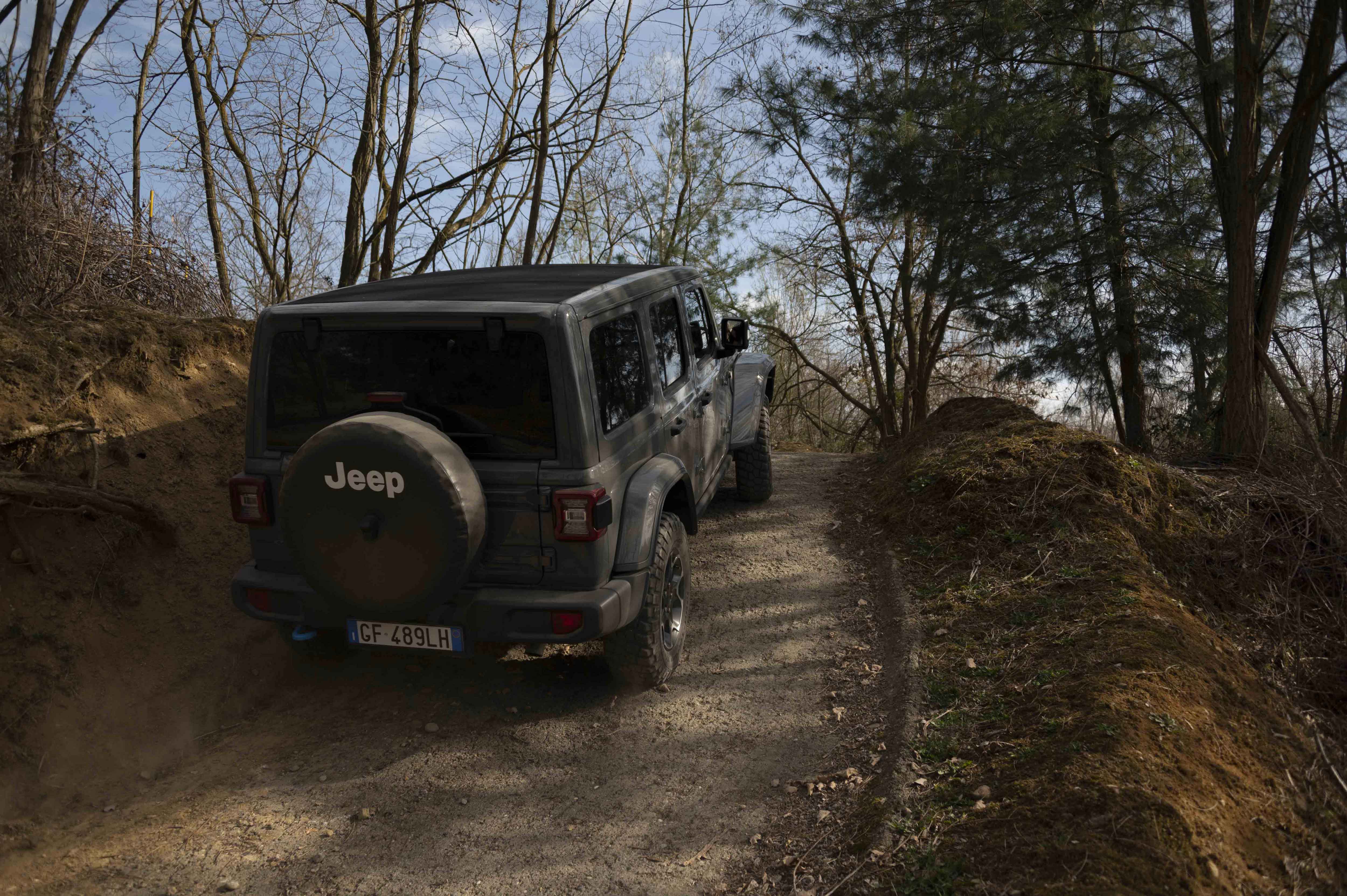 Photo of a gray Jeep on the dirt road uphill