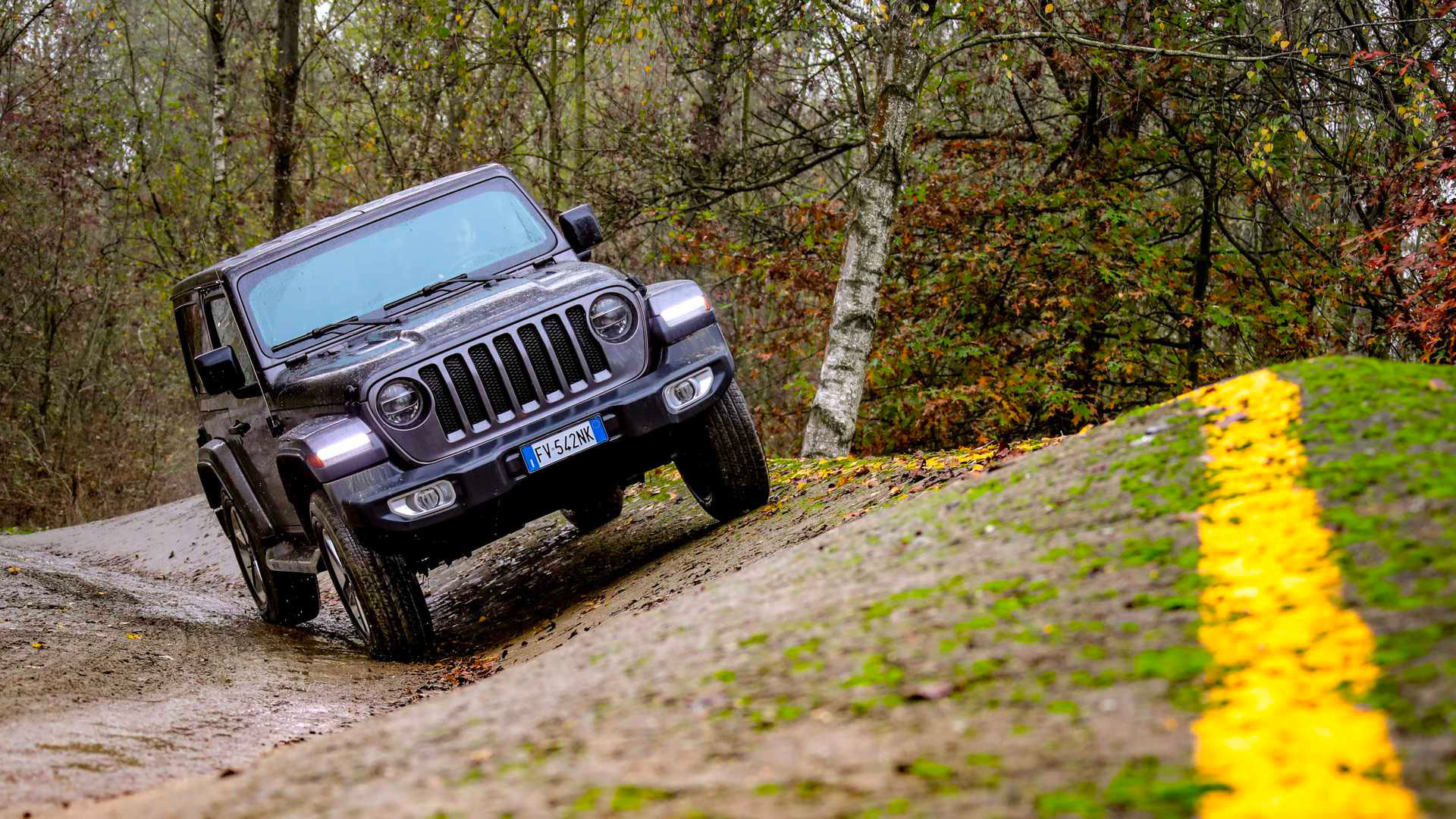 Photo of a black Jeep tackling a sloping obstacle on the Off Road Trail