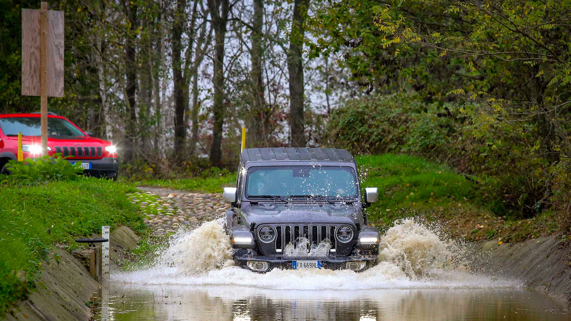 Photo of a black Jeep tackling a flooded ford