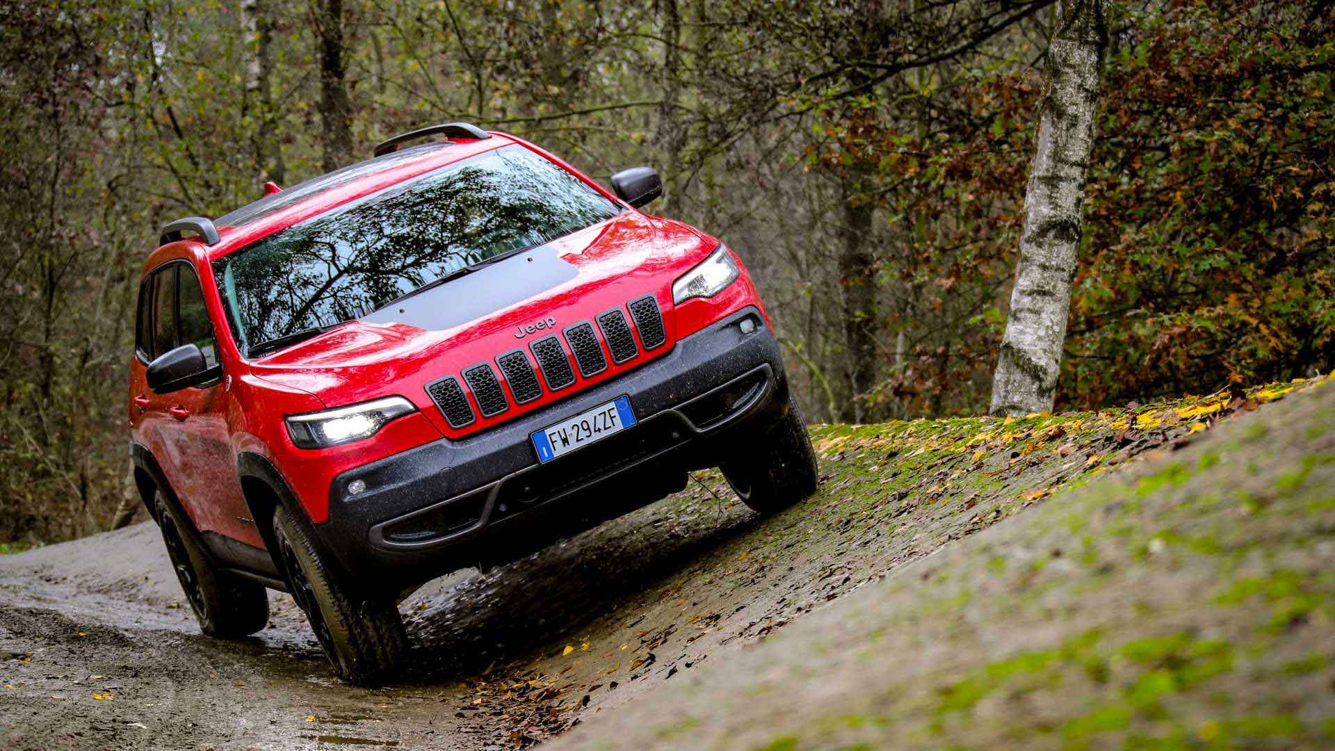 Photo of a red Jeep on a slope