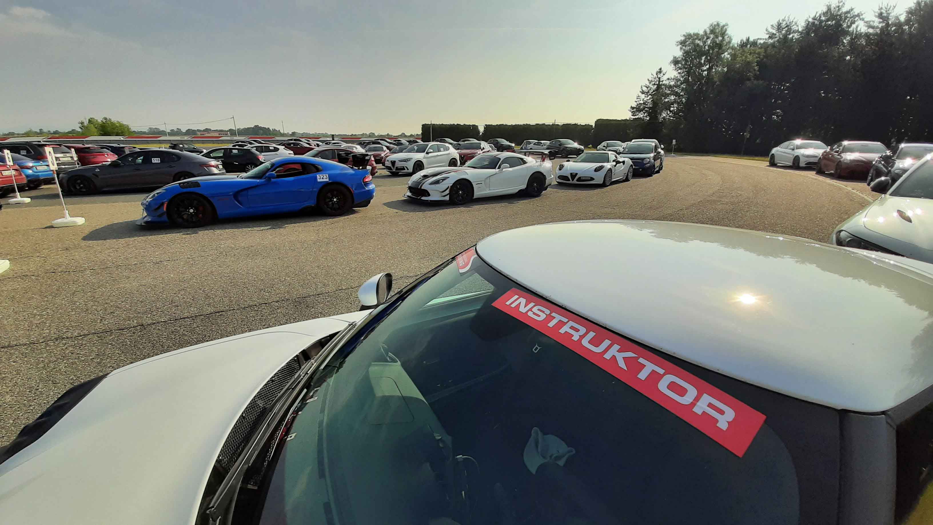 Photos of several cars parked for an event